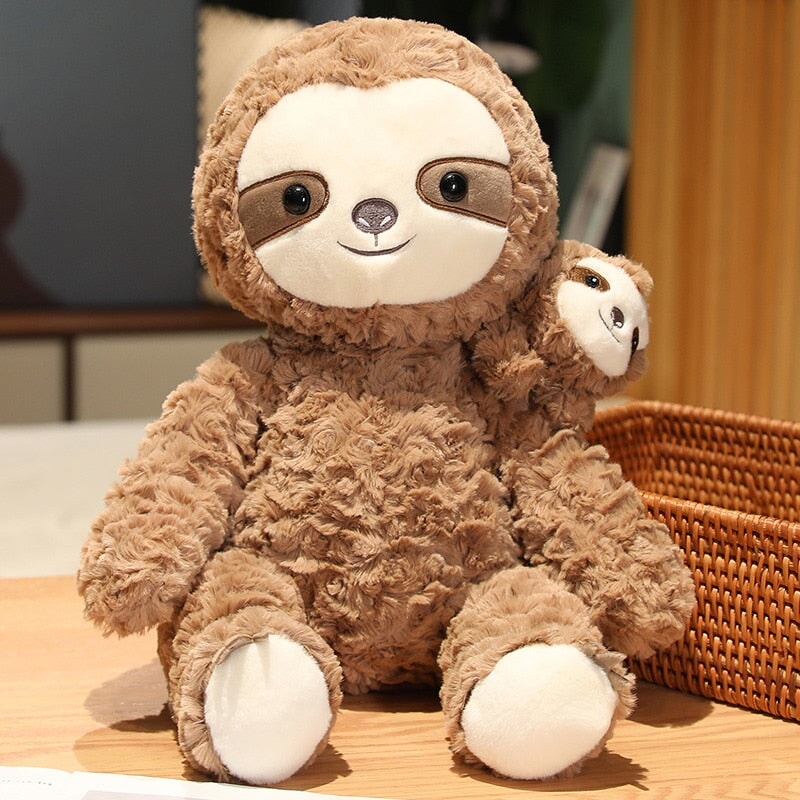 baby sloth hugging stuffed animal